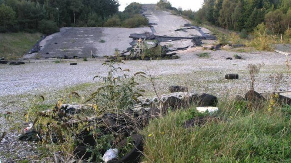 Disused dry ski slope This used to be a popular dry ski slope. It now lies derelict, stripped of its special surface.