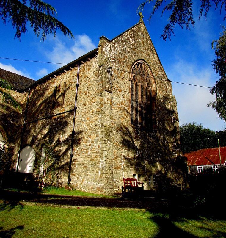 East side of St Paul's Church, Newbridge. Located on the north side of High Street, the Parish Church of St Paul Newbridge is part of the Church in Wales Diocese of Monmouth. The rusty church hall roof is in the background.