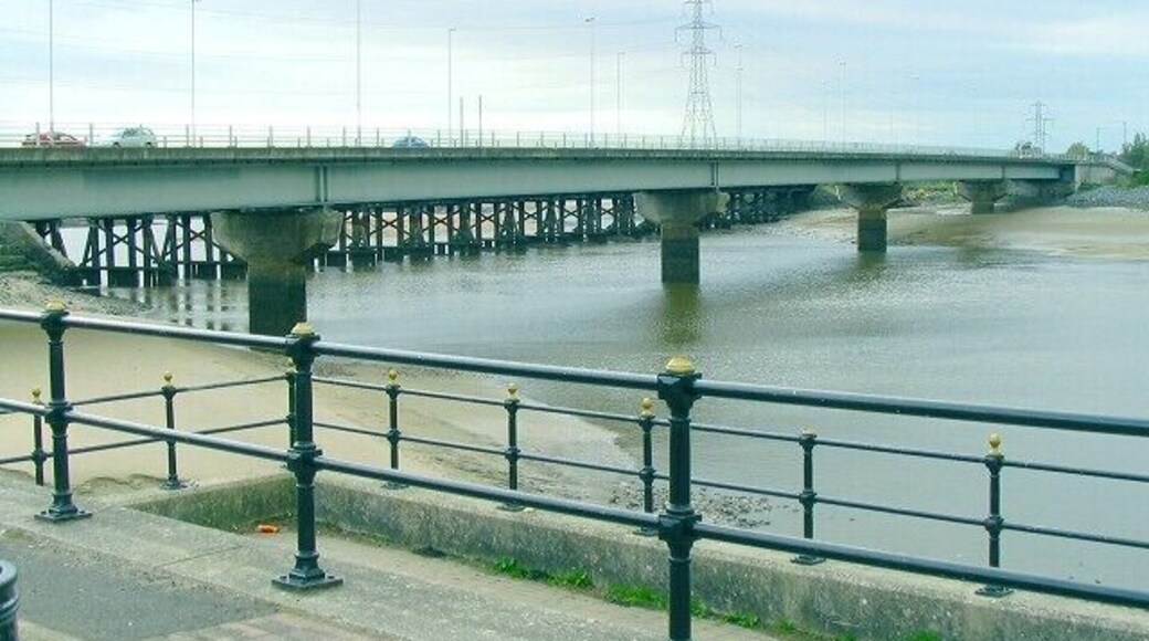 Loughor bridge The road from Llanelli runs over the Loughor estuary towards Gorseinon. Just behind it the supports of the parallel rail bridge can be seen. This is the view from a view point on the east bank, upstream.