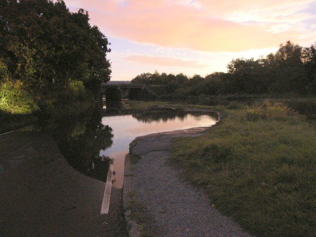 Autumn spring tide floods river Lliw The river Lliw, a tributary of the river Loughor floods within minutes becoming almost impassable. Impossible for cars (though some tried to our amusement) but if you own a Jeep 4X4 just some fun in a day's driving! This happens about 3-4 times a year on high spring tides - it can get a lot higher than this on especially high tides! Picture was taken about 45 minutes after sunset and the light is predominantly moonlight and residual sunlight. The picture is of a submerged road, layby and in the distance the West Wales railway line bridge just in front of the main road bridge.