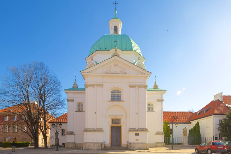 A church with a green dome and a white facade.