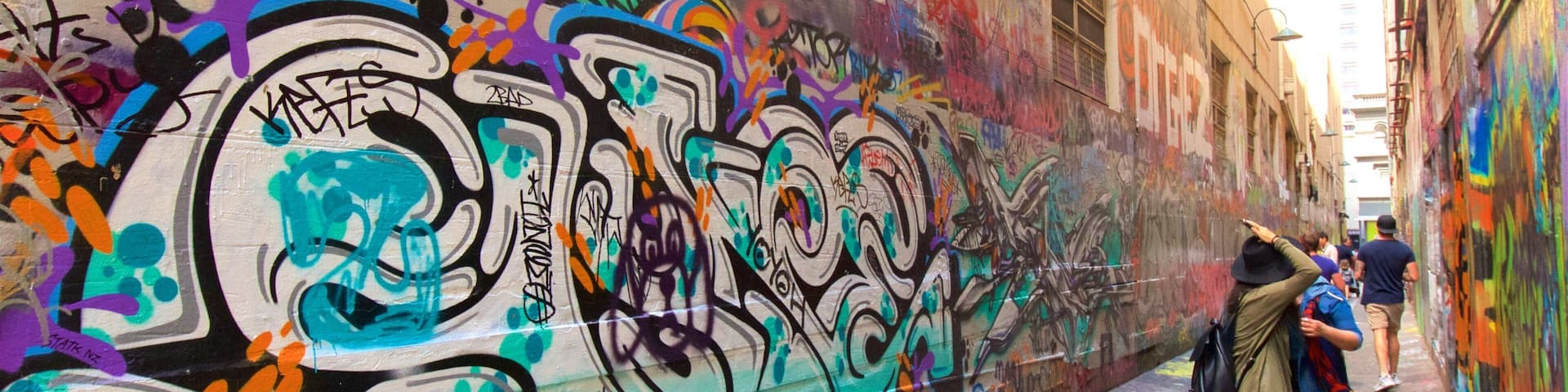 Melbourne showing outdoor art as well as a small group of people