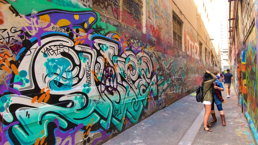 Melbourne featuring outdoor art as well as a small group of people