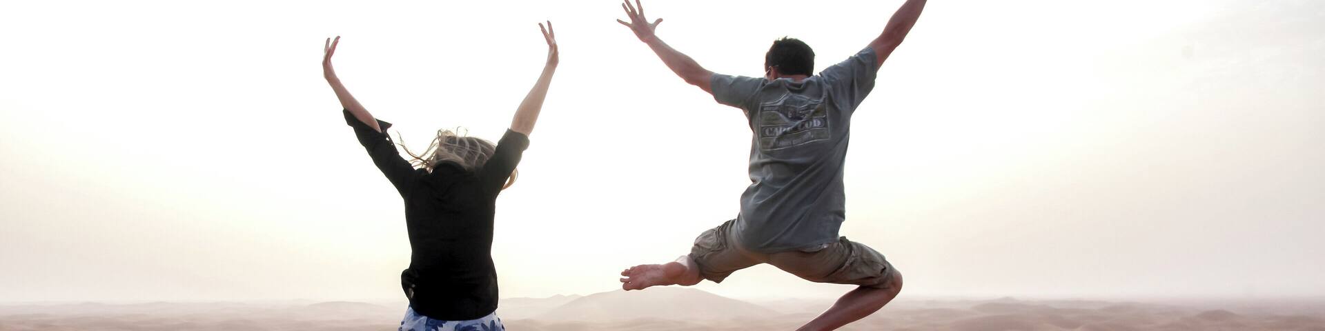 People jump in the Chegaga dunes in the Sahara desert in Morocco.