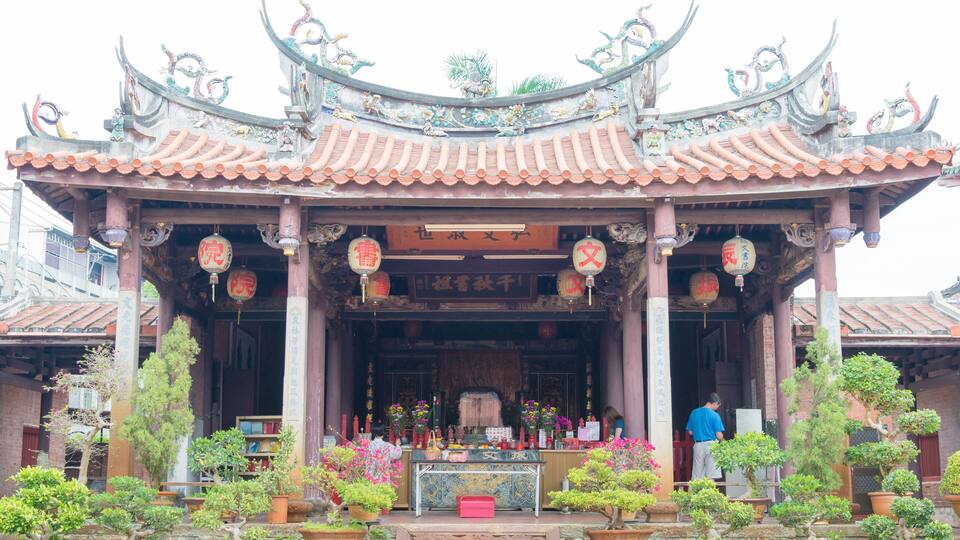 A traditional Chinese temple with ornate architecture, including curved roofs and intricate decorations.