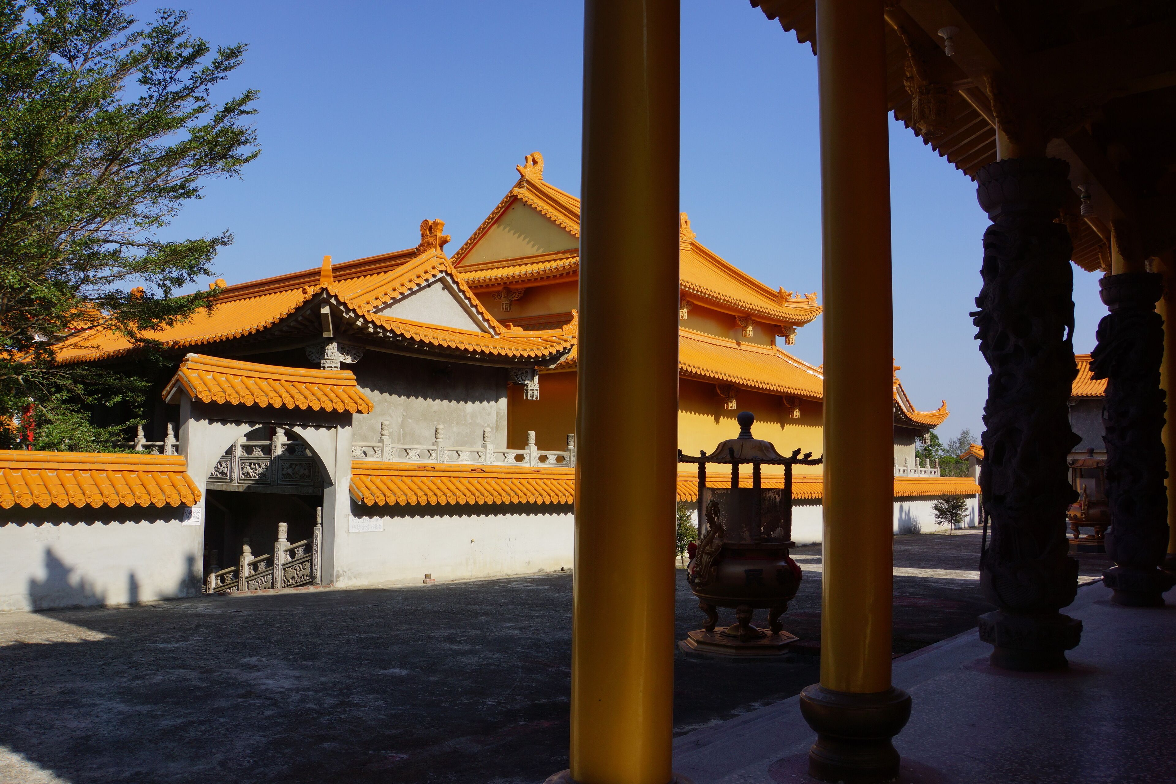 A traditional building with orange-tiled roofs and ornate columns.
