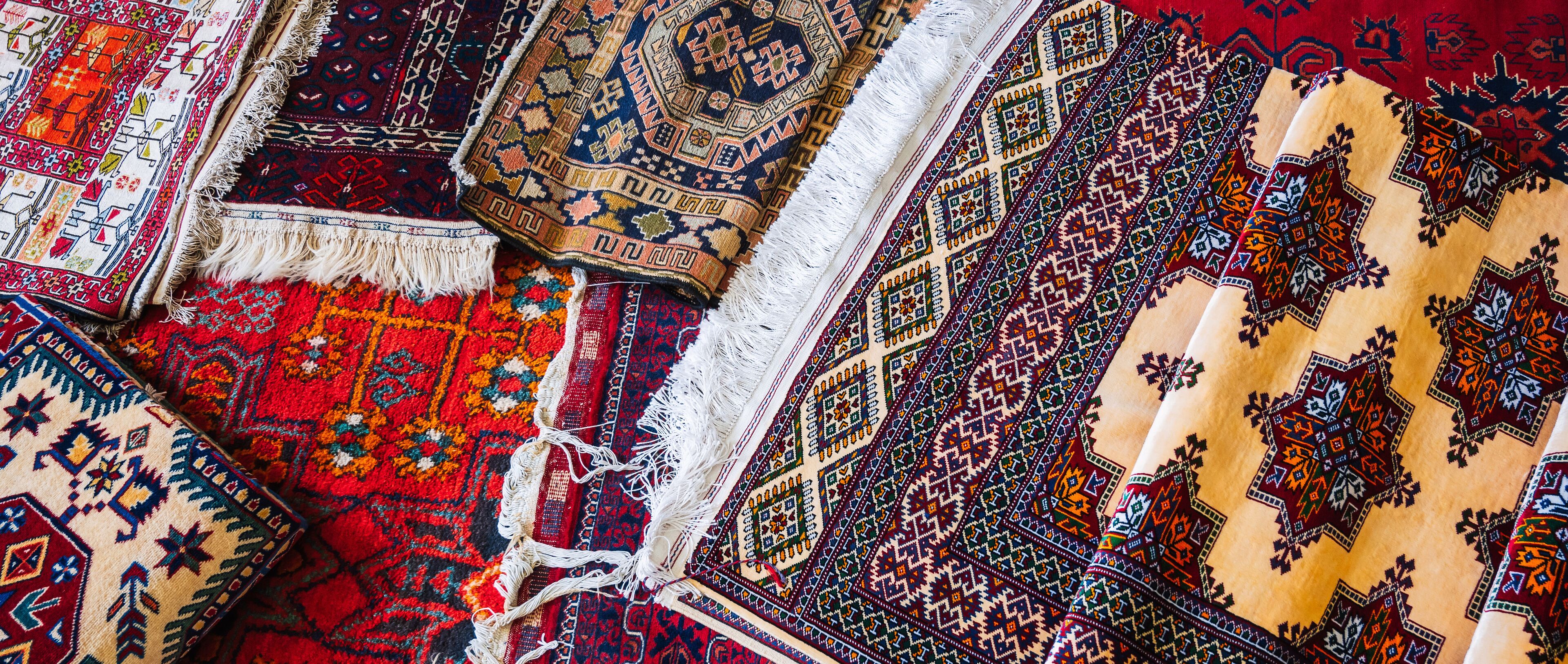 A collection of intricately patterned rugs with various designs and colors.