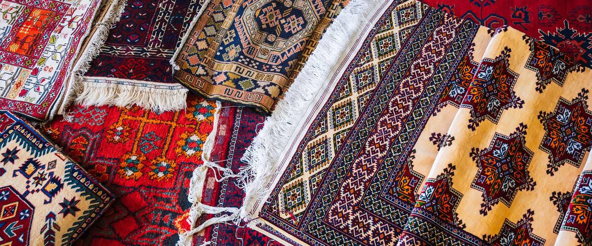 A collection of intricately patterned rugs with various designs and colors.