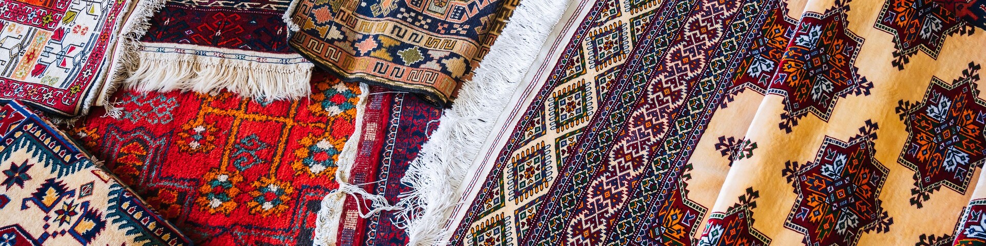 A collection of intricately patterned rugs with various designs and colors.