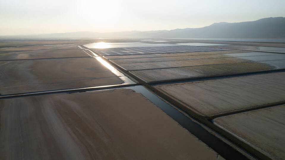 Aerial view of a beautiful salt farm with tranquil water reflections and serene fields, Dazkiri, Turkey.