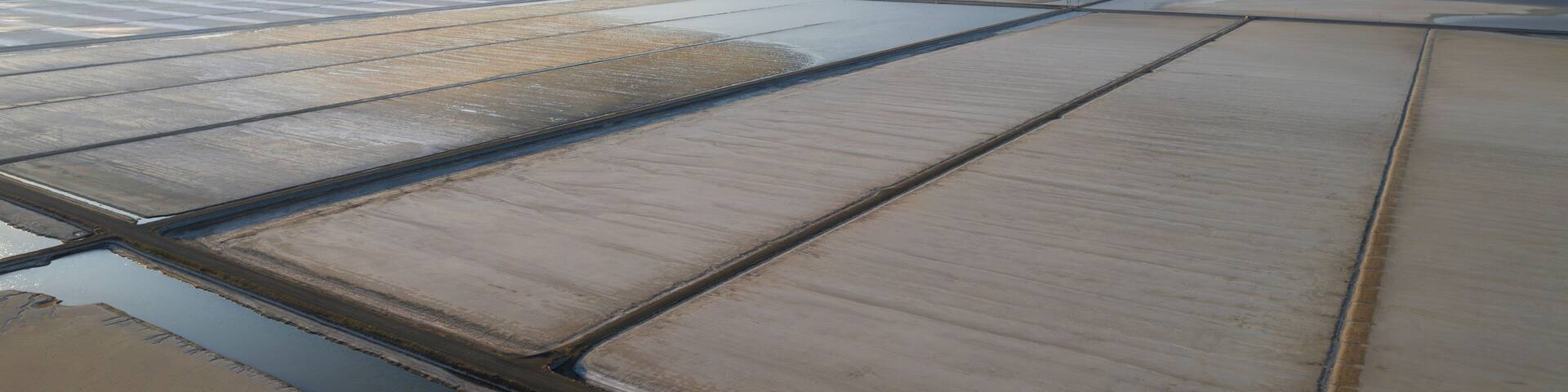 Aerial view of colorful salt farm and wetlands with textured patterns, Dazkiri, Turkey.