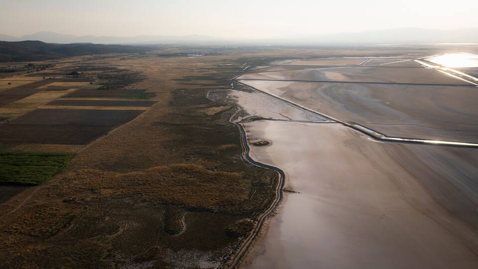 Aerial view of beautiful salt farm fields with tranquil water and expansive landscape, Dazkiri, Turkey.