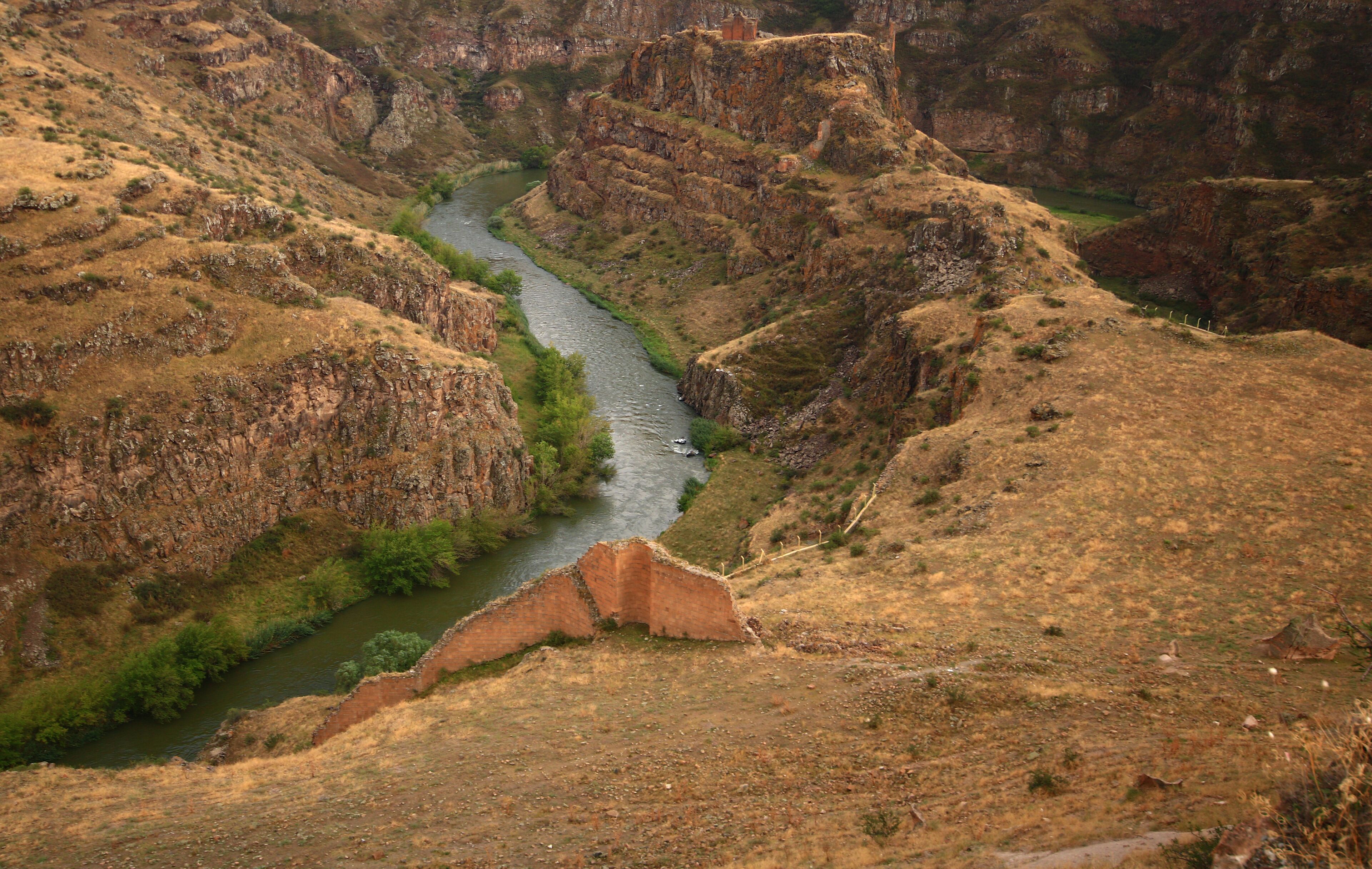 A canyon with a river winding through it.