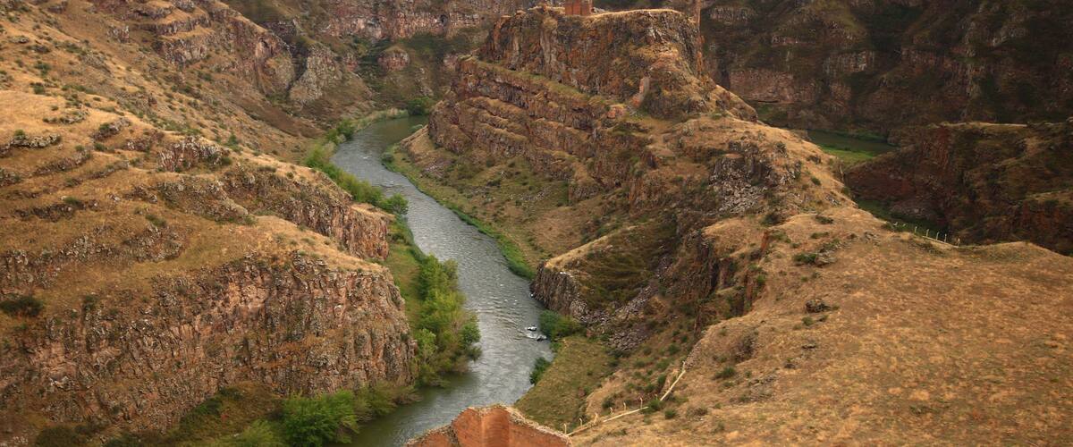 A canyon with a river winding through it.