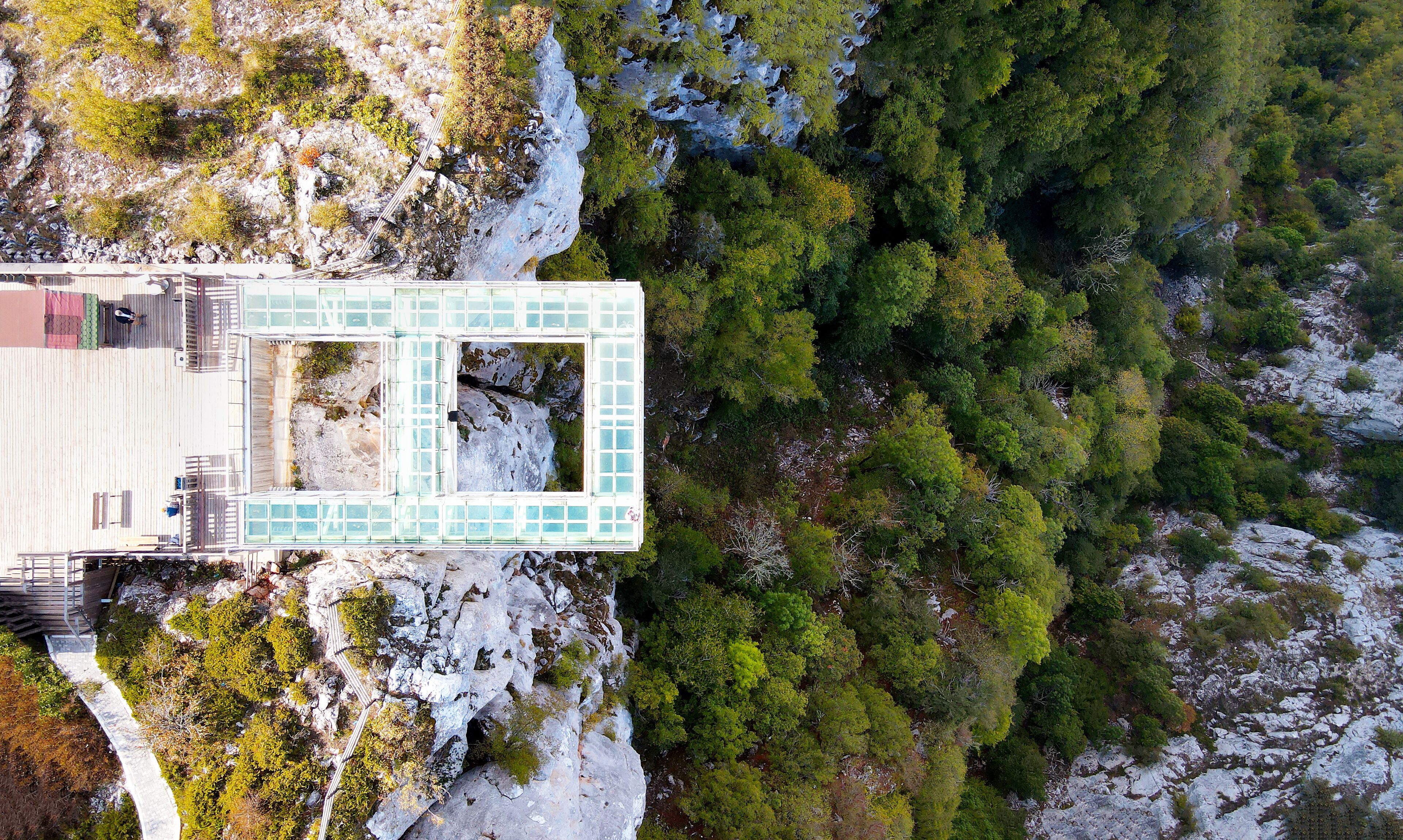 The scenic aerial view of Çatak Kanyonu, with people enjoying the autumn season on the glass sightseeing terrace at 450 m height, with an amazing panorama, Kastamonu, Turkey
