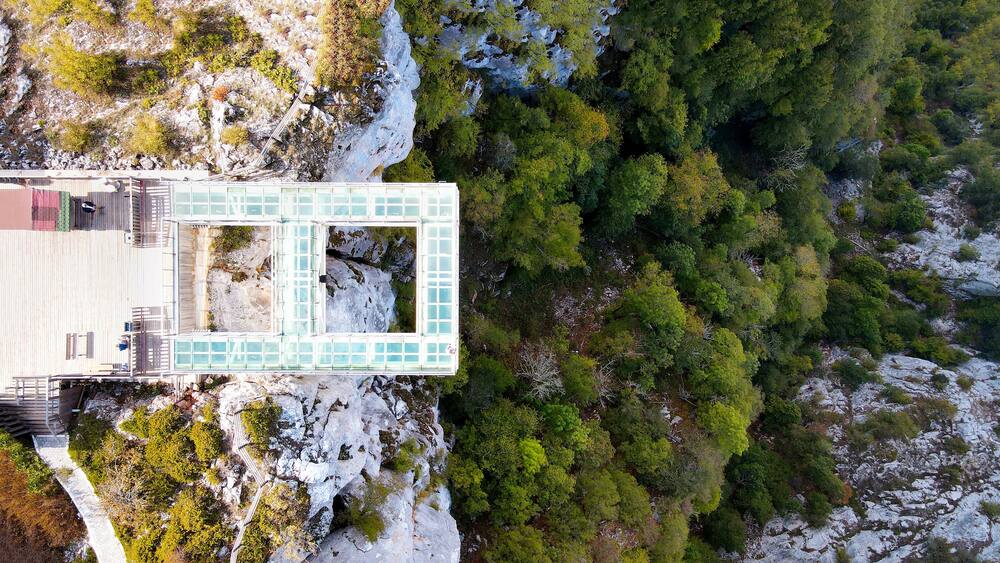 The scenic aerial view of Çatak Kanyonu, with people enjoying the autumn season on the glass sightseeing terrace at 450 m height, with an amazing panorama, Kastamonu, Turkey