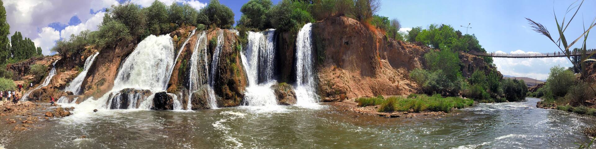 muradiye waterfall, van province turkey. open air view of trees and exuberant waterfall.
