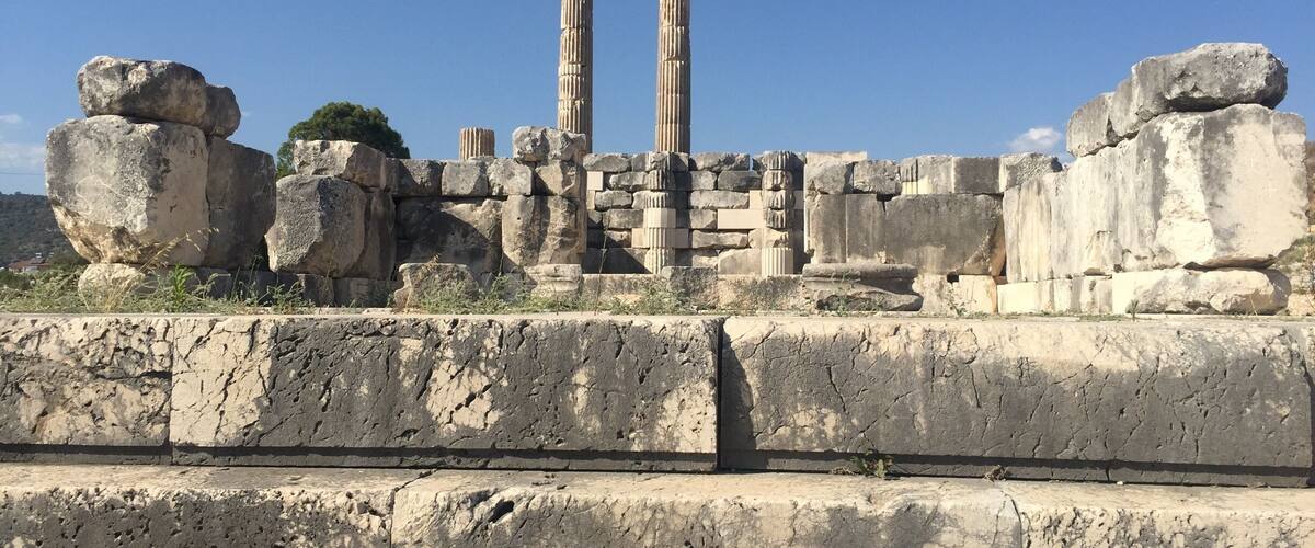 Ancient stone ruins with large boulders and columns.