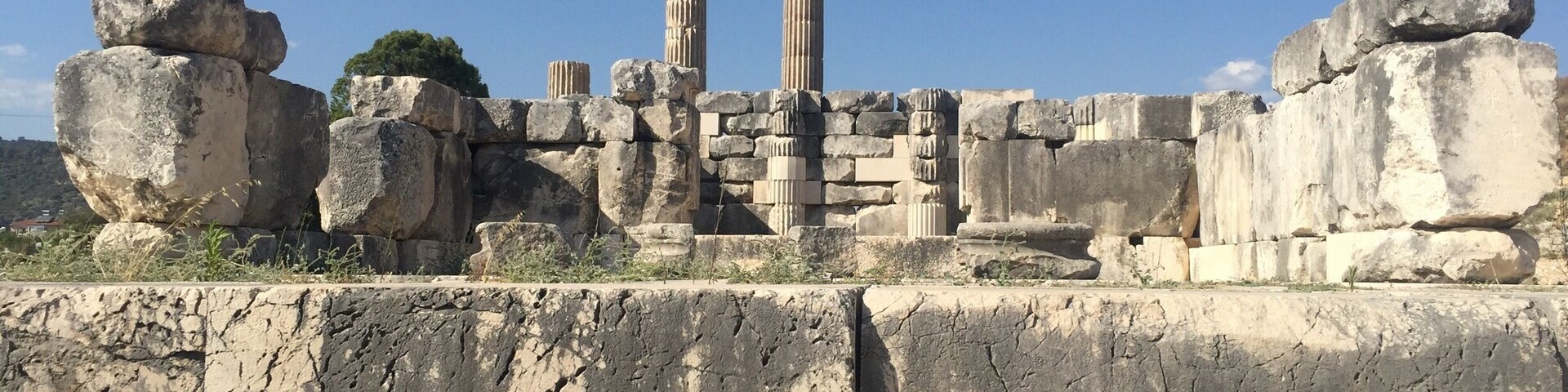 Ancient stone ruins with large boulders and columns.