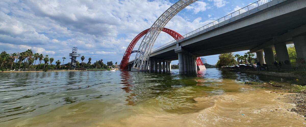 The newly built concrete bridge over the Seyhan River connects the eastern Yuregir and western Seyhan district centers in Adana city, enhancing urban connectivity and growth.