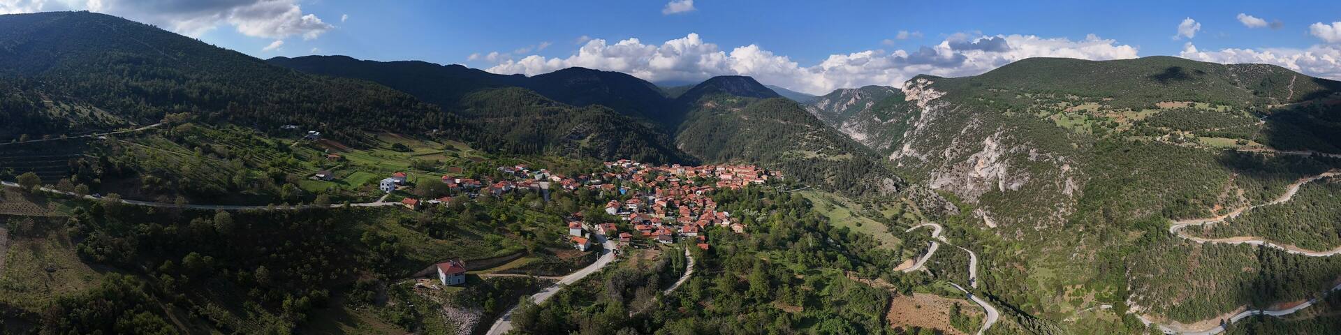 Aerial view of Gelemiç village in Keles, Bursa, Turkey. Surrounded by green hills and forests, this peaceful rural landscape showcases nature, traditional homes, and winding mountain roads Turkiye