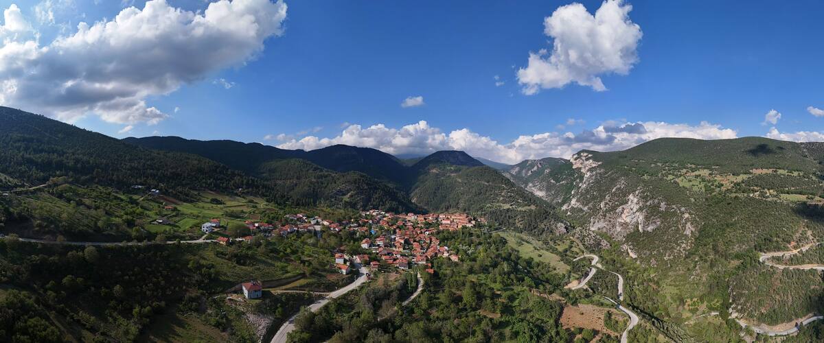 A mountainous landscape with a village nestled in the valley.