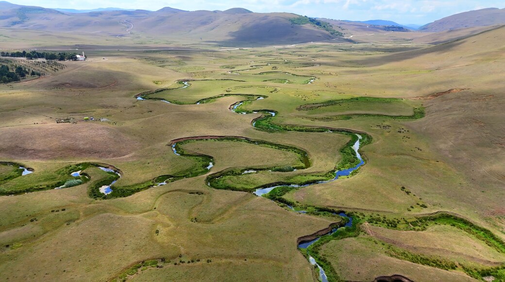 The Perşembe Yaylası is the summer pastureland of Perşembe district. Panoramic View of Meandering Stream and Majestic Mountains in Perşembe Plateau, Ordu, Turkiye.