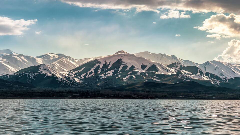 Mystery view from snowy peaks and lake Panorama
