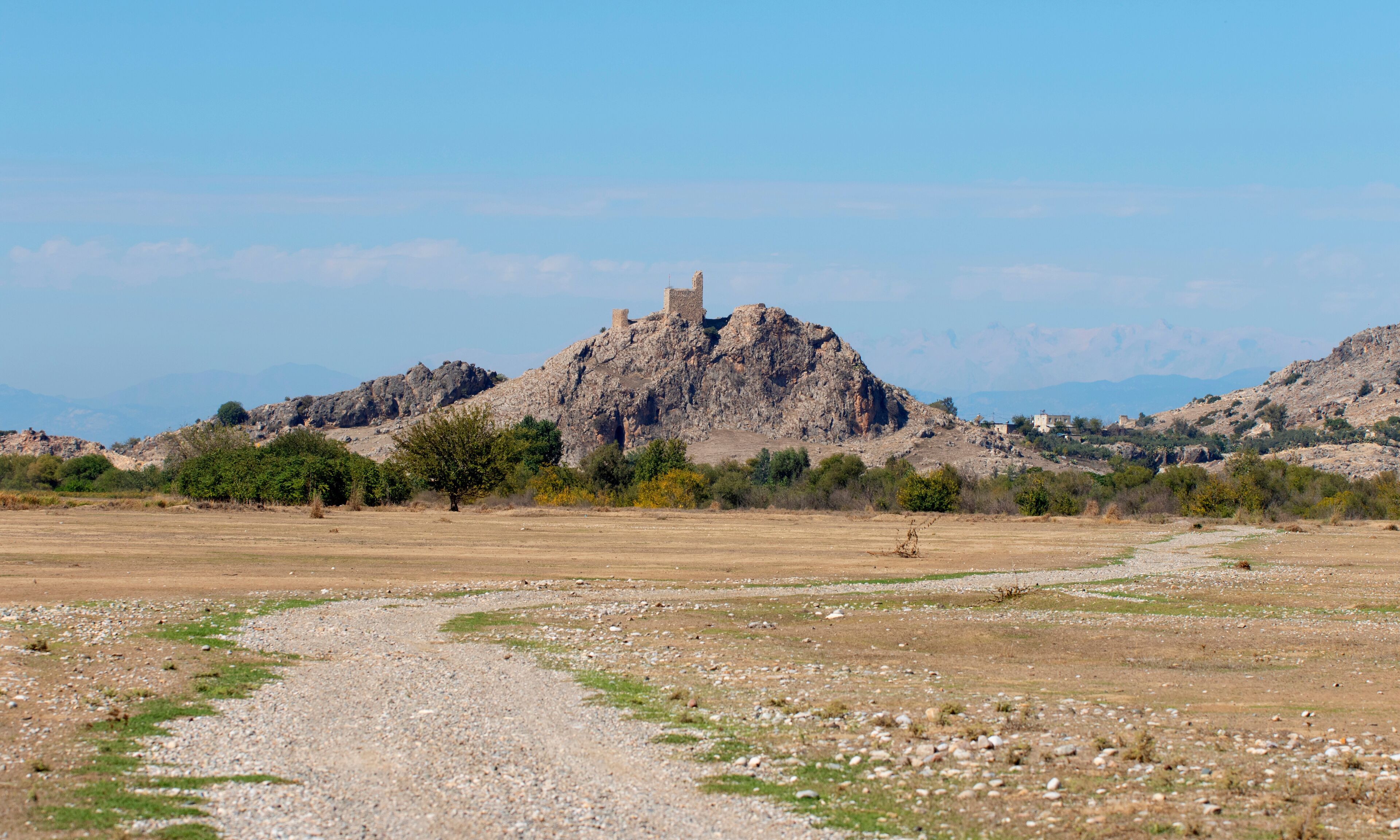 Distant view of Amouda Castle (Hemite Kalesi), a medieval fortress in Osmaniye province in southern Turkey, built on rocky cliffs, offering panoramic views for visitors in the autumn