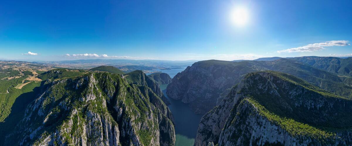 A mountainous landscape with a deep valley and a river.