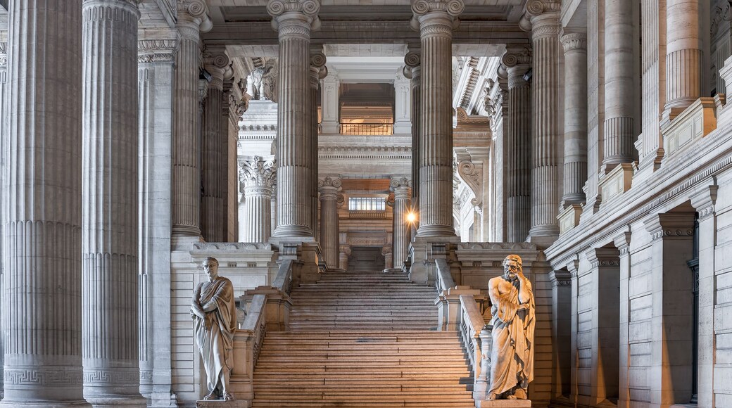 A grand staircase with classical columns, leading to an upper level.