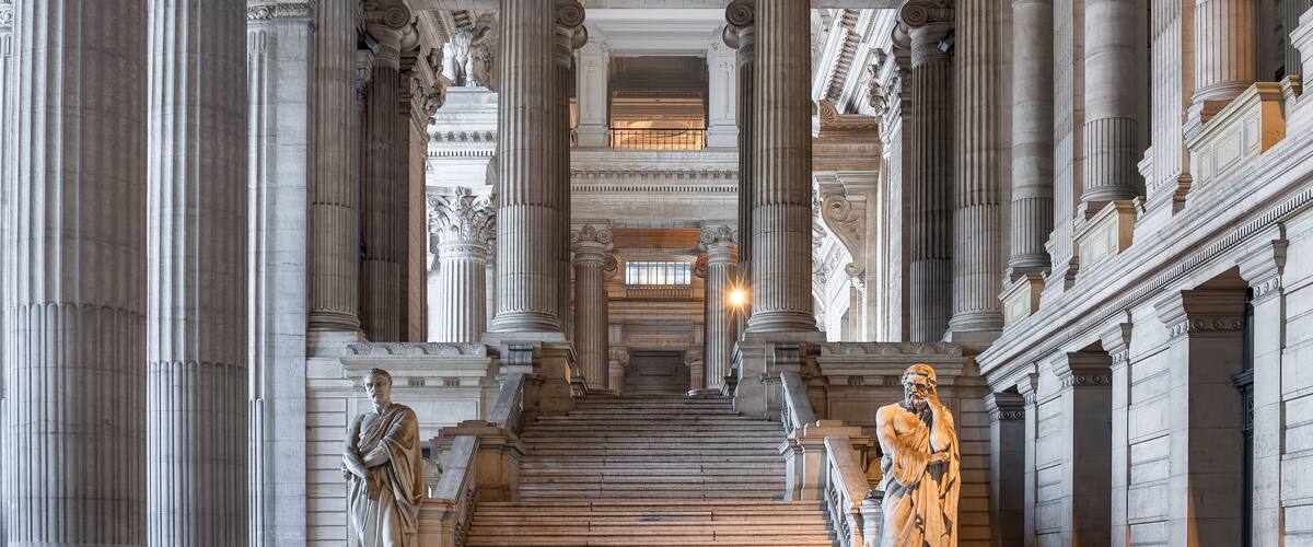 A grand staircase with classical columns, leading to an upper level.