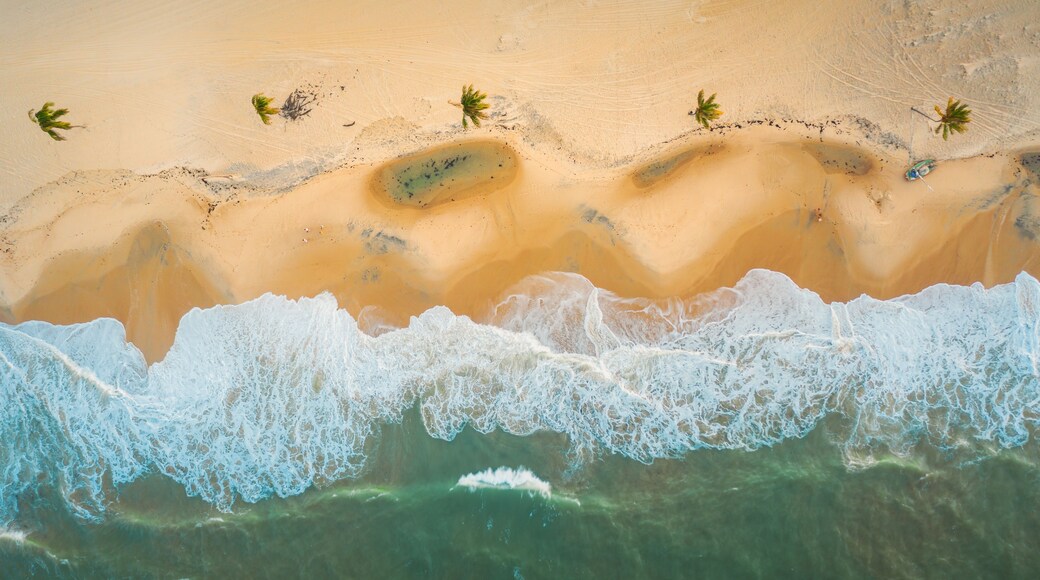 High angle shot of the beautiful foamy waves in Northern Brazil, Ceara, Fortaleza/Cumbuco/Parnaiba