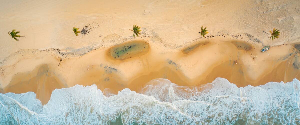High angle shot of the beautiful foamy waves in Northern Brazil, Ceara, Fortaleza/Cumbuco/Parnaiba