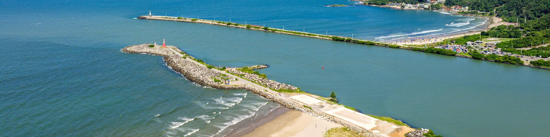 Aerial view of Itajai breakwater and Navegantes lighthouse with turquoise sea and green hills, Santa Catarina.