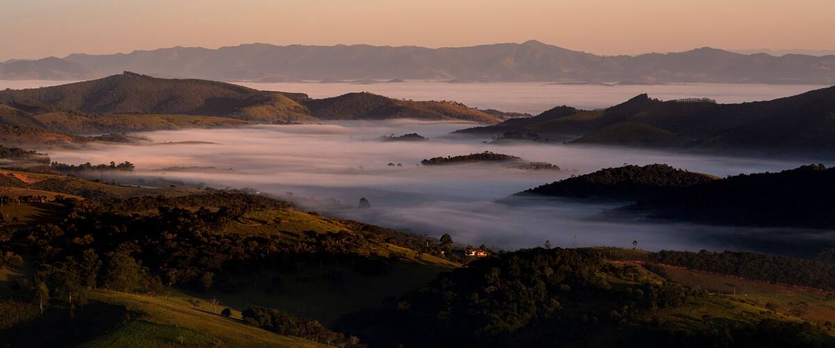 Rolling hills, a valley, and distant mountains.