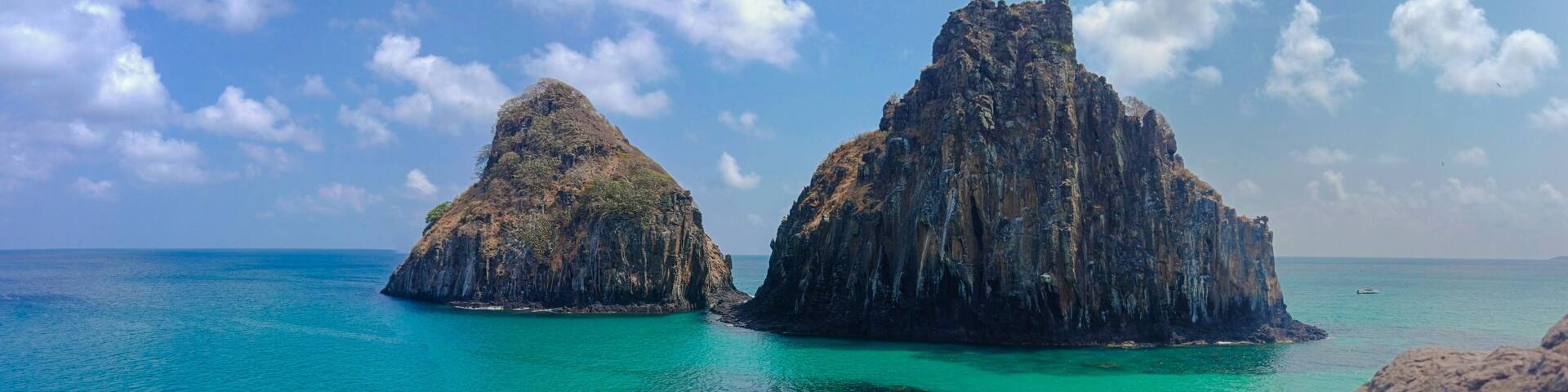 Two rocky islands surrounded by turquoise waters.