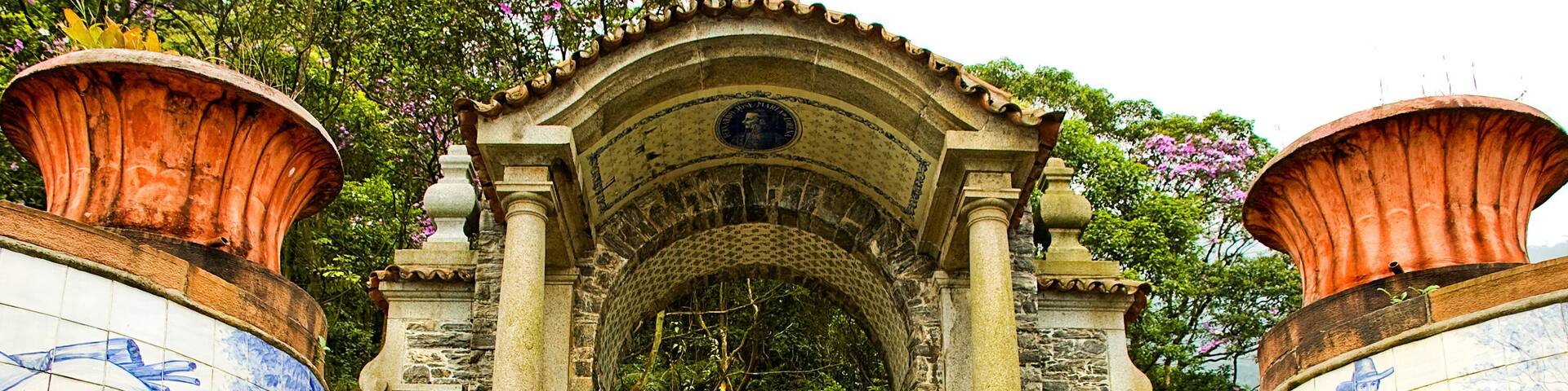 A stone staircase leading to a tiled archway with blue horse and rider scenes.