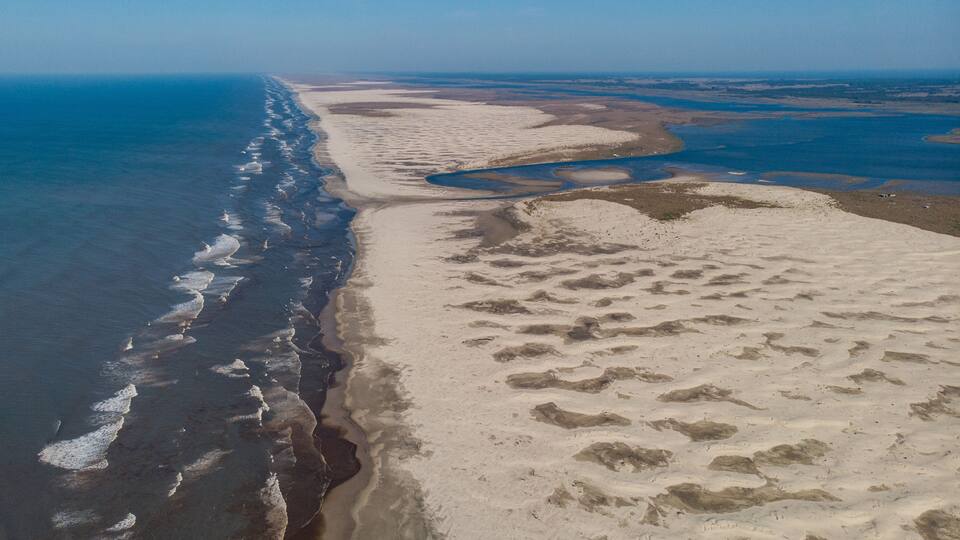 Aerial image of the dunes between Barra da Lagoa do Peixe, National Park, and the Atlantic Ocean at Praia de Tavares, Rio Grande do Sul, Brazil.