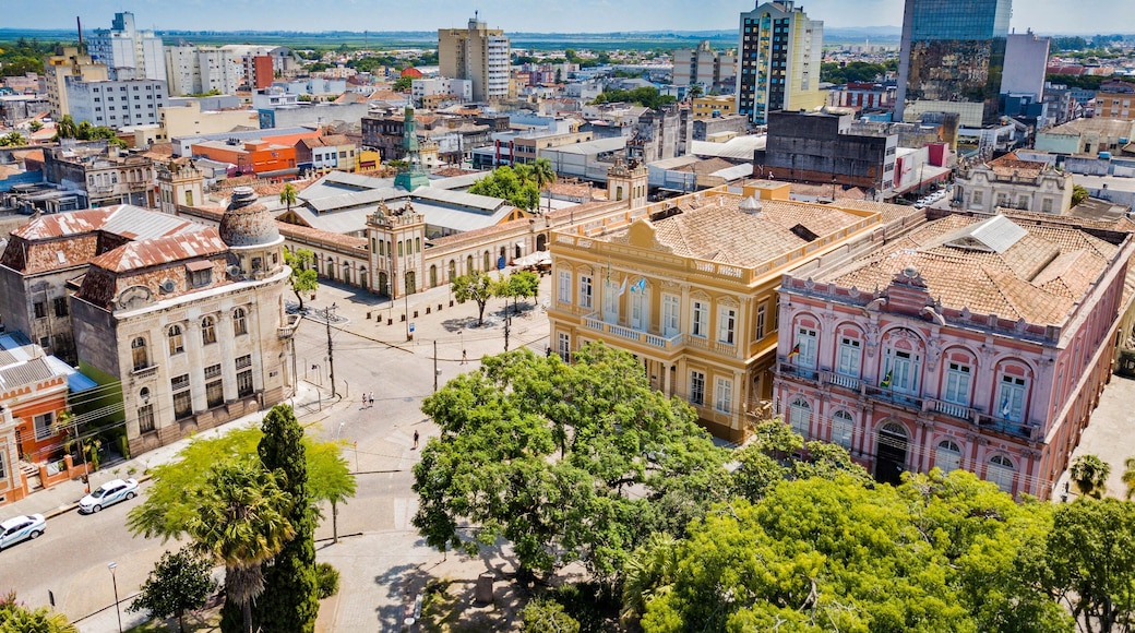 A cityscape with historic buildings, a modern skyscraper, and a central plaza.