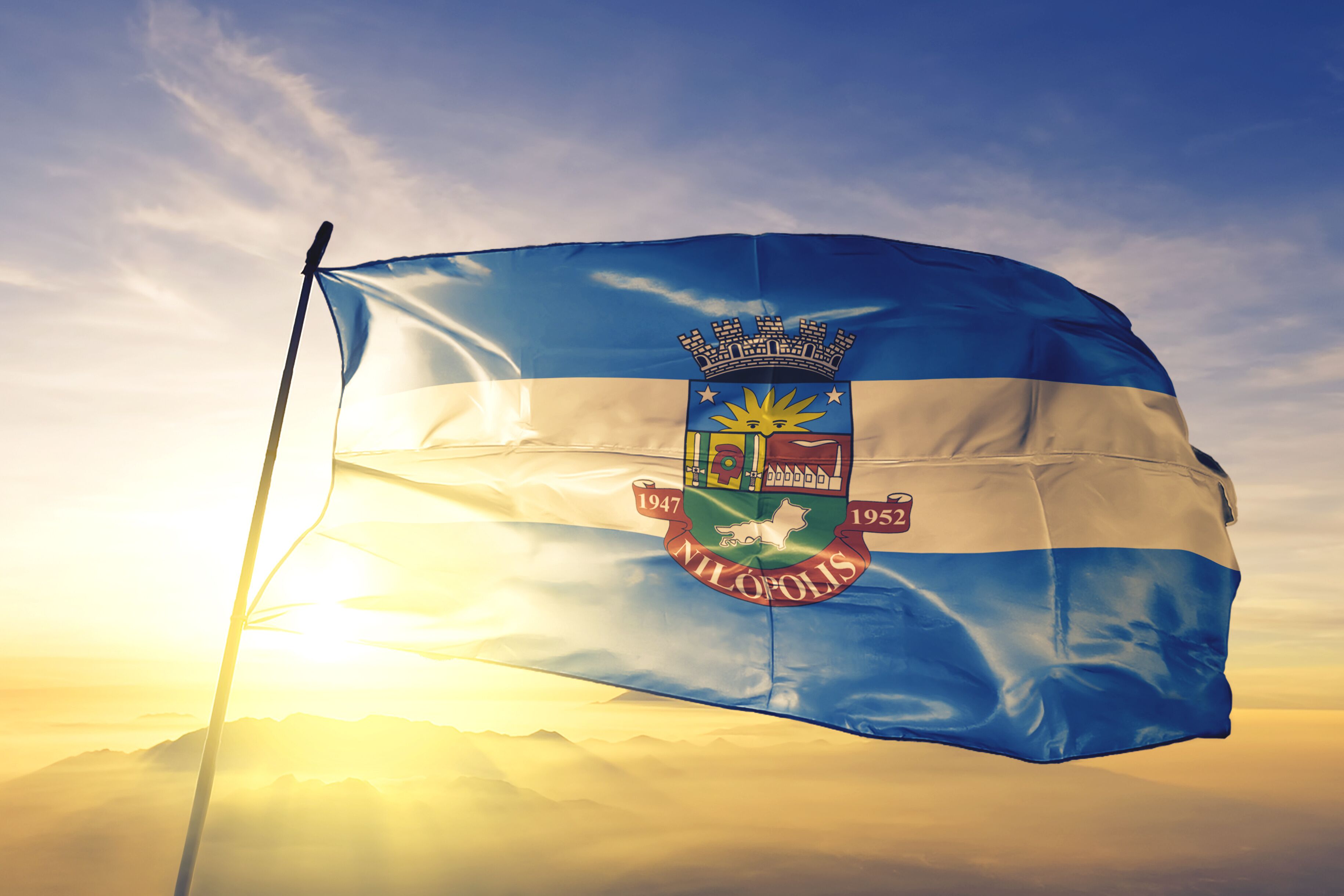 Nilopolis of Brazil flag waving on the top sunrise mist fog