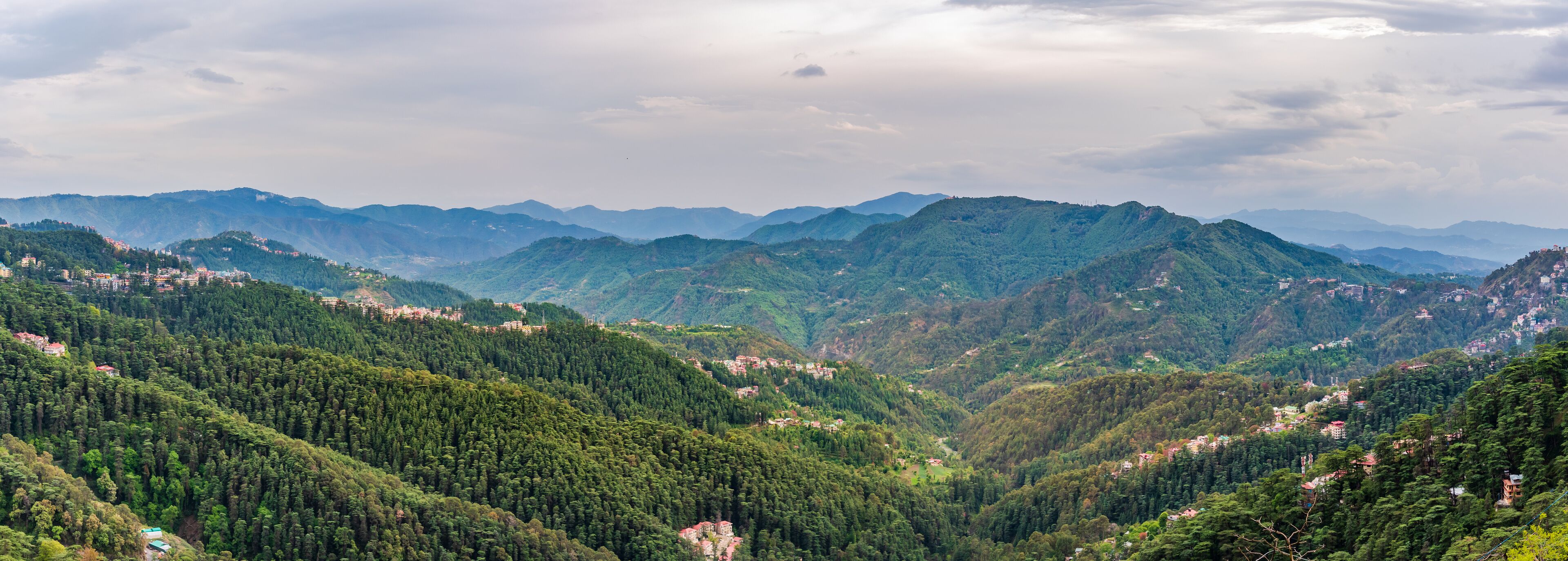 A mountainous landscape with dense forests and scattered settlements.