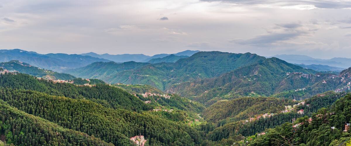 A mountainous landscape with dense forests and scattered settlements.