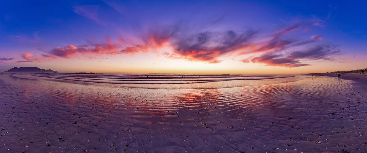 Glorious African sunset Panorama of Big Bay beach and Table mountain a stunning vision in Cape Town, South Africa