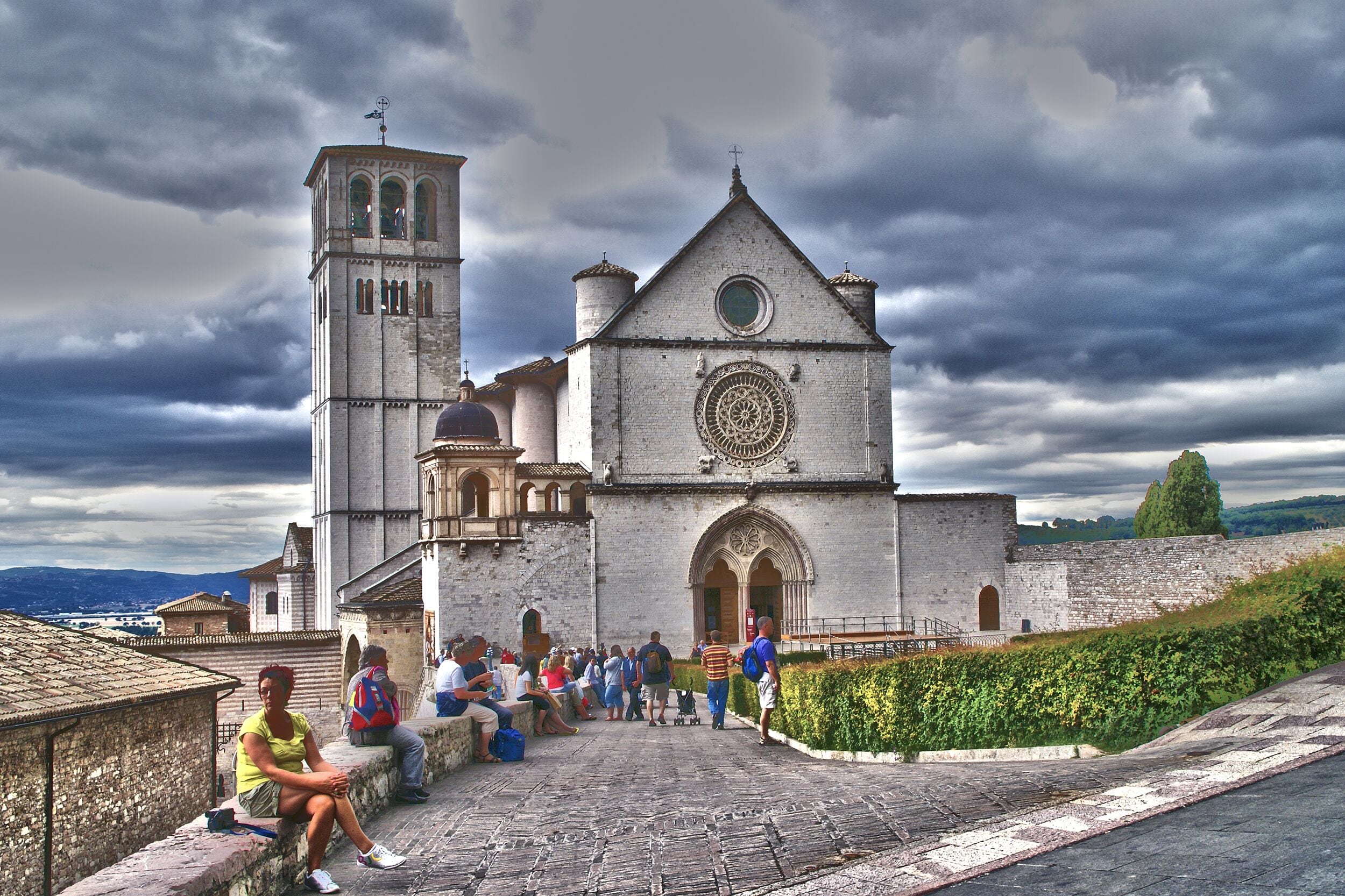 A historic church with a bell tower and a large circular window.