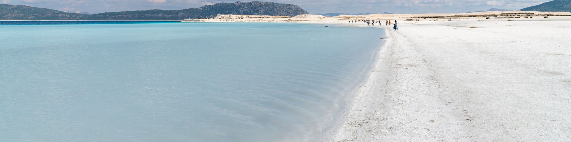 Tourists walking in the beach of Salda Lake, Burdur, Turkey
