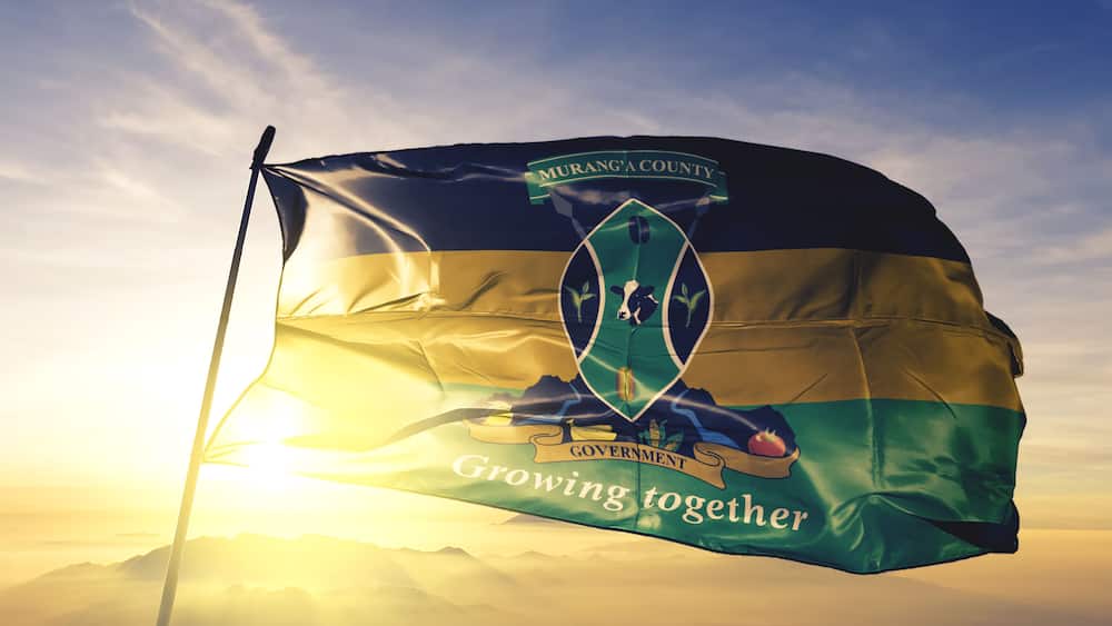 Murang'a county of Kenya flag waving on the top sunrise mist fog