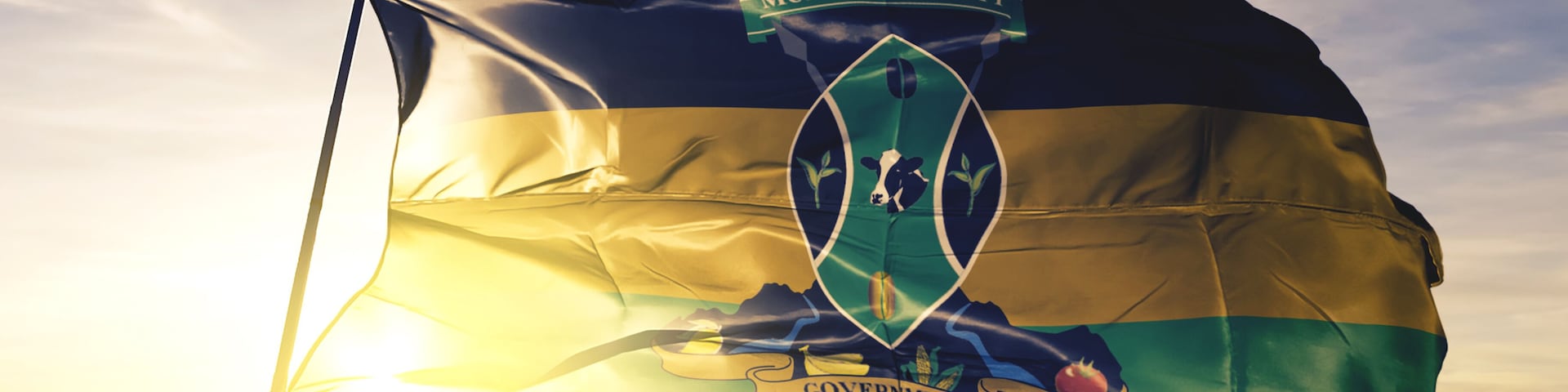 Murang'a county of Kenya flag waving on the top sunrise mist fog