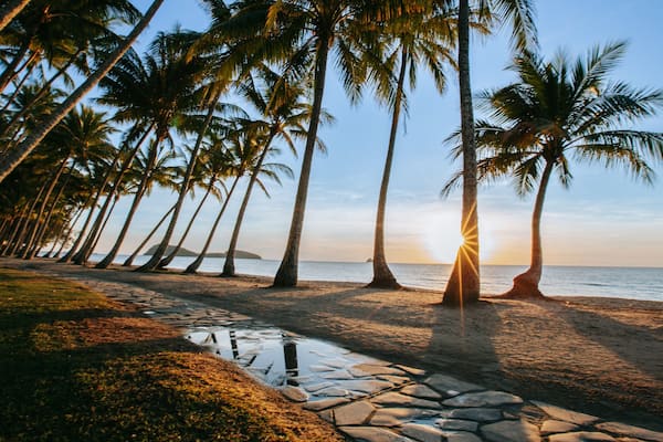 Cairns showing a sunset, general coastal views and a beach
