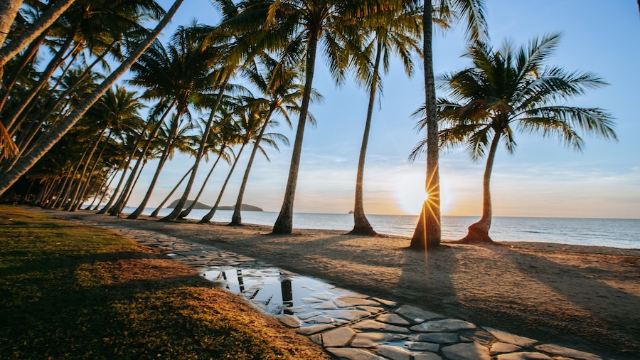 Cairns showing a sunset, general coastal views and a beach
